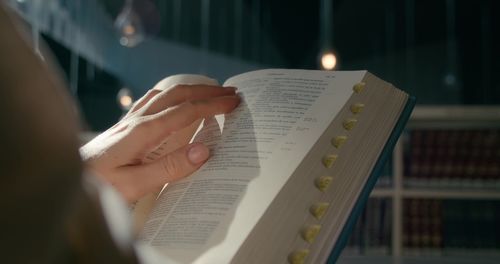 Cropped hand of woman reading book