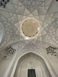 Low angle view of chandelier hanging on ceiling in building