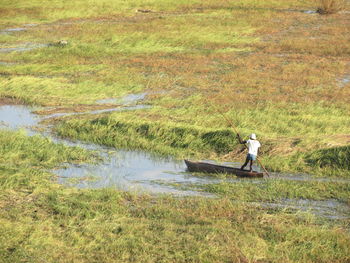 Rear view of man riding in boat