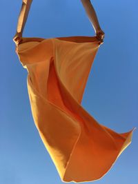 Low angle view of flag against clear blue sky