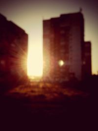 Silhouette of buildings against sky at sunset