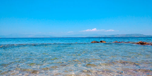 Scenic view of sea against blue sky
