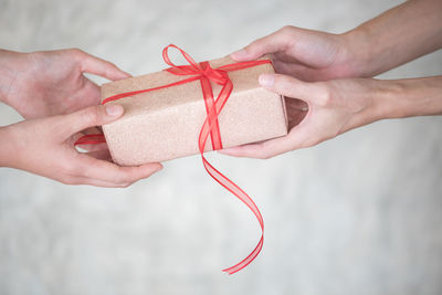 Close-up of hands holding gift box