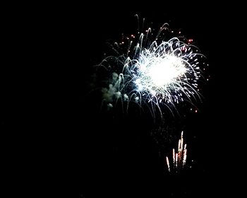 Low angle view of firework display at night