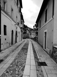 Empty alley amidst buildings in city