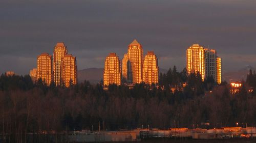 Skyscrapers in city at dusk