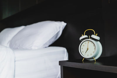 Close-up of white sleeping on bed at home