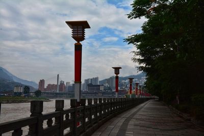 View of city buildings against cloudy sky