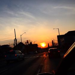 Traffic on road during sunset