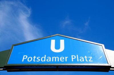 Low angle view of potsdamer platz sign against blue sky