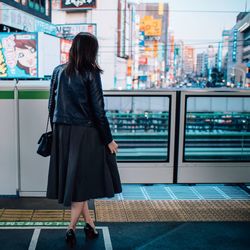 Rear view of woman walking in city