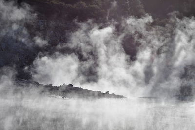 Smoke emitting from volcanic mountain against sky