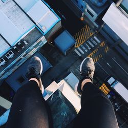 Low section of woman sitting on building terrace