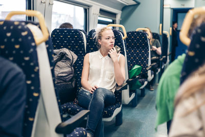 Portrait of woman sitting in train