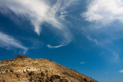 Low angle view of mountain against blue sky