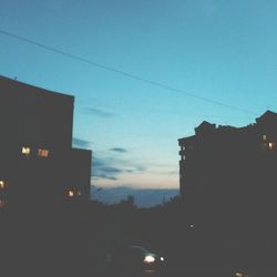 Silhouette of buildings against sky at dusk