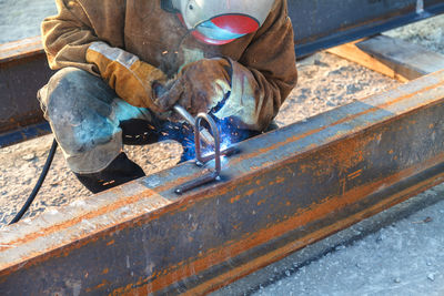 Welder welding at construction site