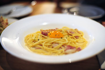 Close-up of pasta served in plate on table 