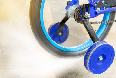 Closeup of spinning children bicycle chain wheel.