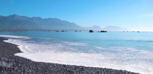 Scenic view of sea against clear blue sky