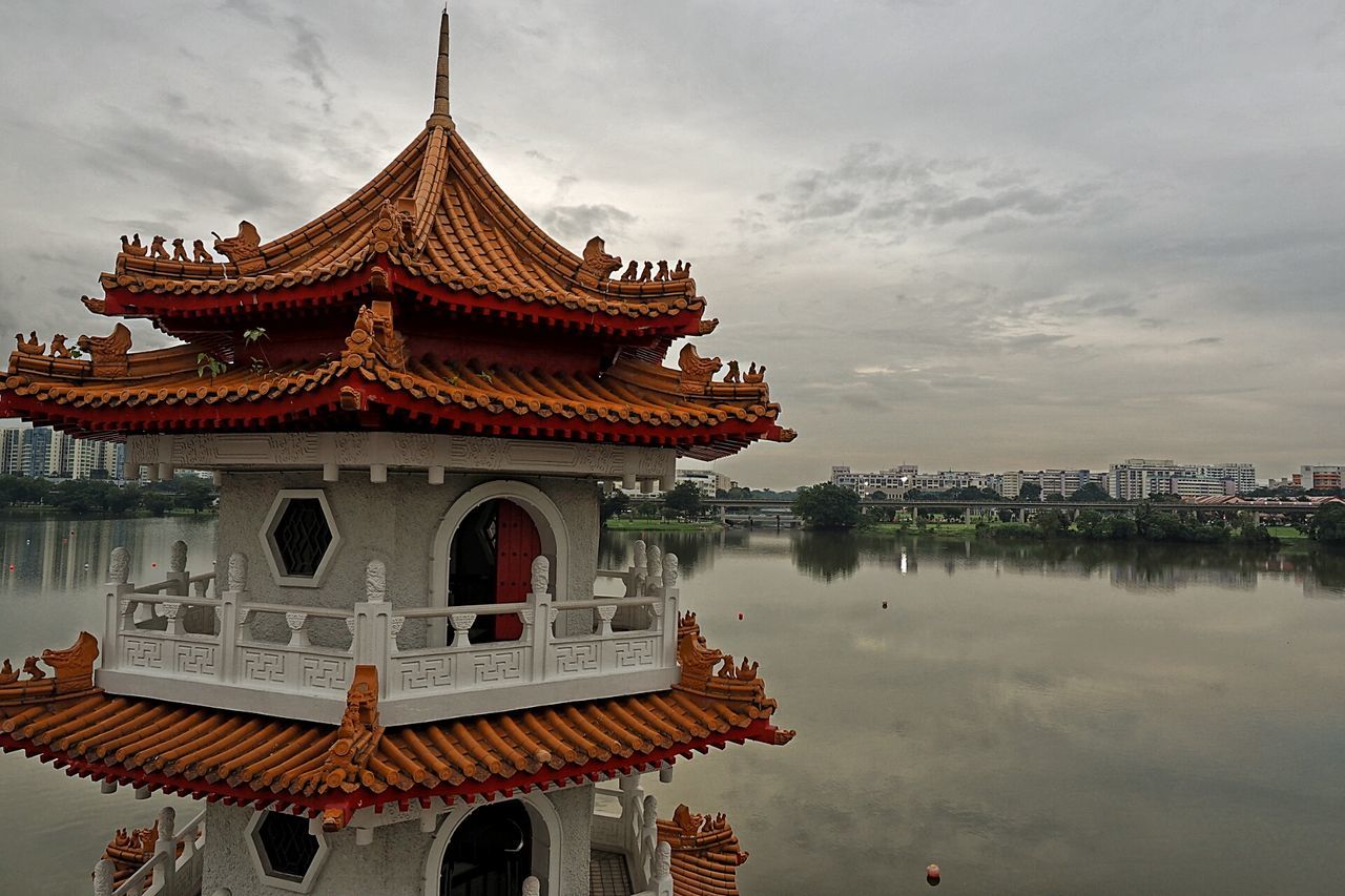 building exterior, architecture, built structure, sky, place of worship, religion, cloud - sky, spirituality, water, cloud, roof, temple - building, outdoors, tradition, travel destinations, travel, house, day, cloudy