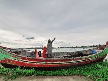 Boats moored on beach against sky