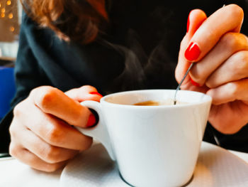 Midsection of woman holding coffee