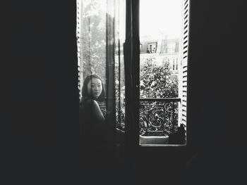 Woman looking through window