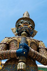Low angle view of statue against blue sky