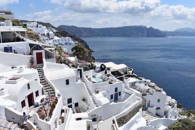 High angle view of townscape by sea against sky