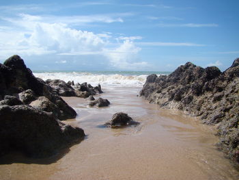 Scenic view of sea against cloudy sky