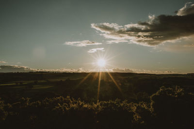 Scenic view of field against sky during sunset