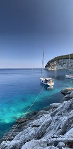 Sailboat in sea against sky