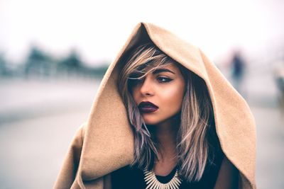 Beautiful woman in jacket looking away