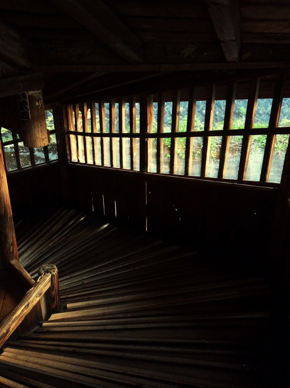 indoors, window, built structure, architecture, wood - material, steps, empty, railing, ceiling, sunlight, absence, staircase, steps and staircases, flooring, shadow, door, house, no people, interior, day