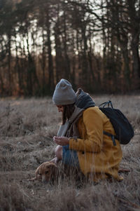 Man with umbrella on field in forest