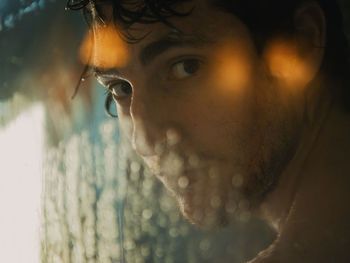 Close-up portrait of young man looking away