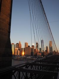 Suspension bridge against clear sky at dusk