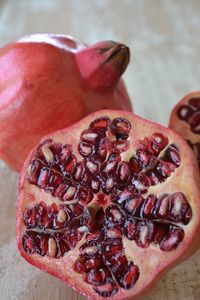 Pomegranate, punica granatum, cut in half showing the juicy arils or seeds