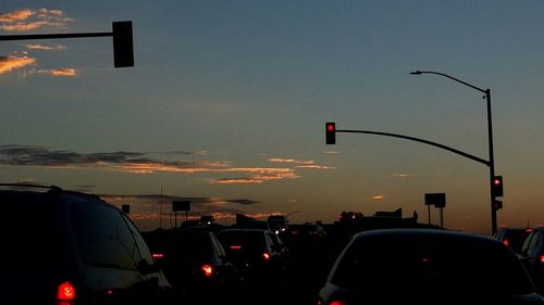 Traffic on road at sunset