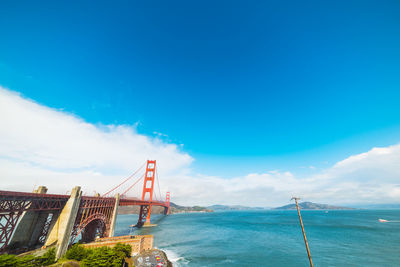 View of suspension bridge against cloudy sky