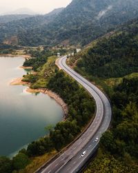 High angle view of road by mountains and sea