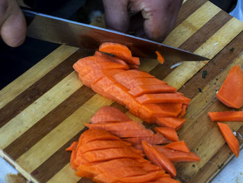 Close-up of person preparing food on cutting board