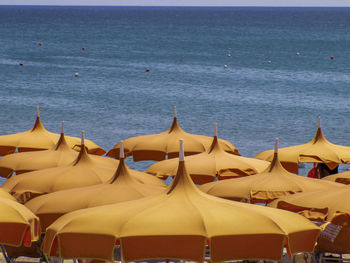 Panoramic view of beach against sky with umbrellas