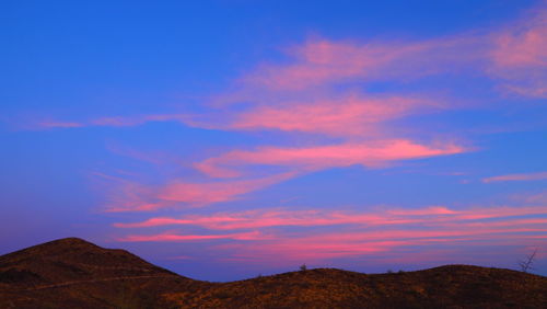 Scenic view of silhouette mountains against sky during sunset