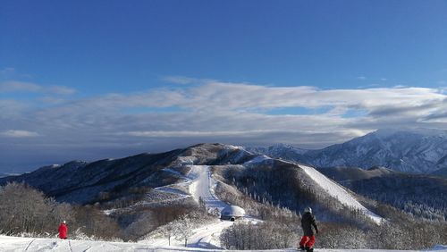 Scenic view of mountains against blue sky