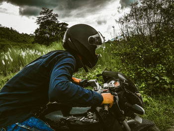 Side view of young man in forest