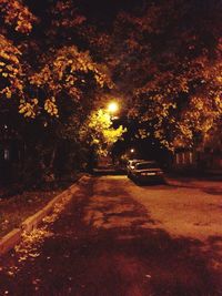 Cars parked on road at night