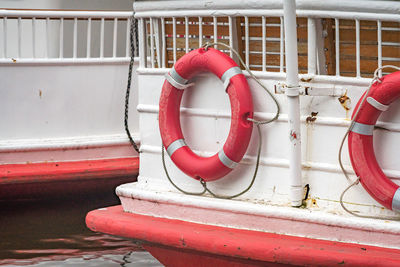 Life belts hanging on boat moored on river