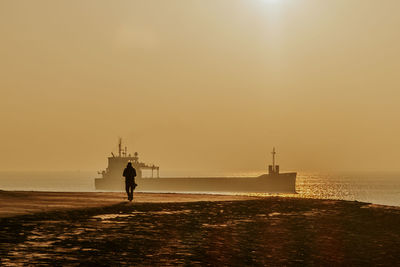 Rear view of man walking on boulevard.